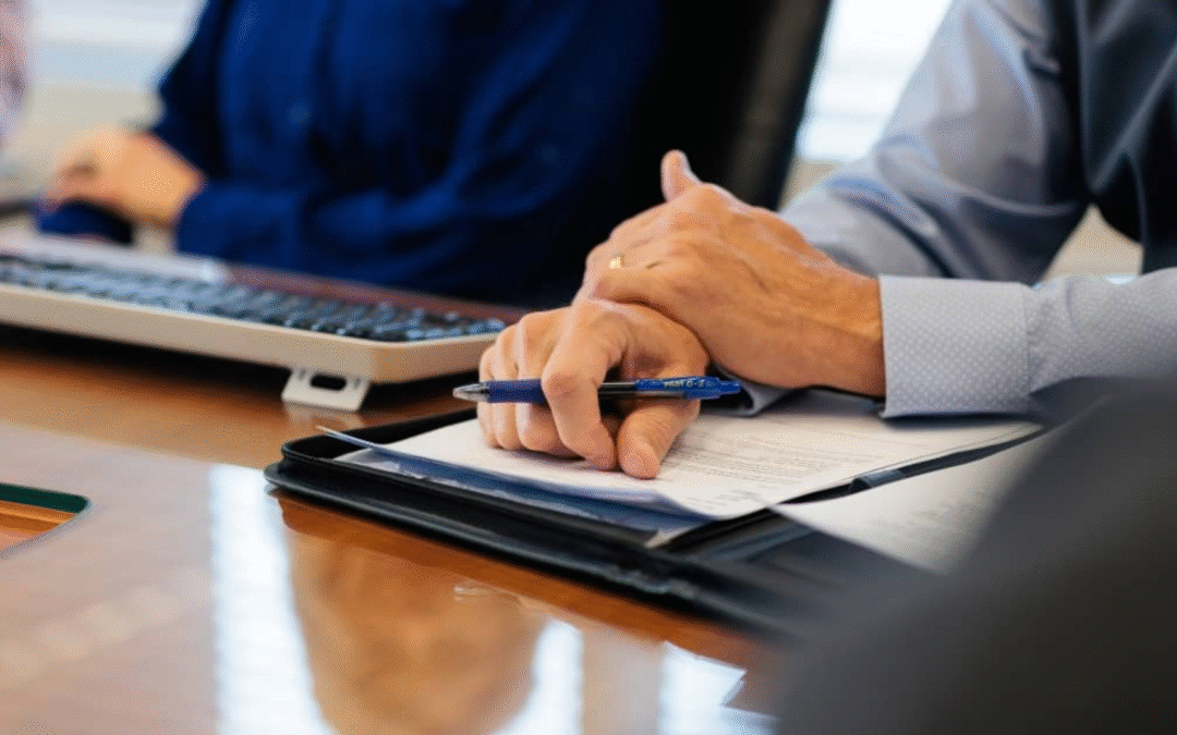 Business buyer and advisor reviewing financials and growth potential during due diligence process